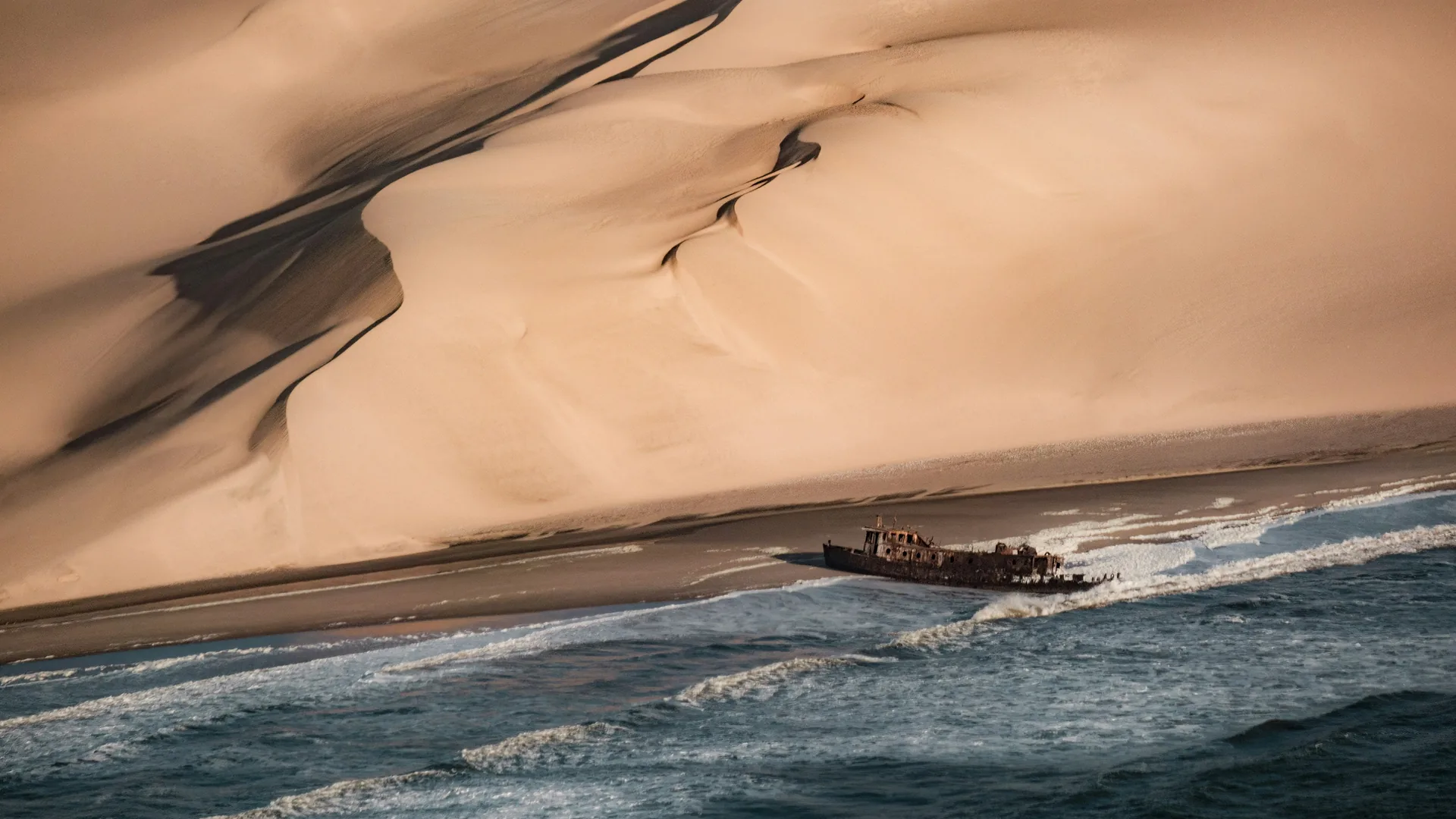 Shipwreck in the surf on the Skeleton Coast